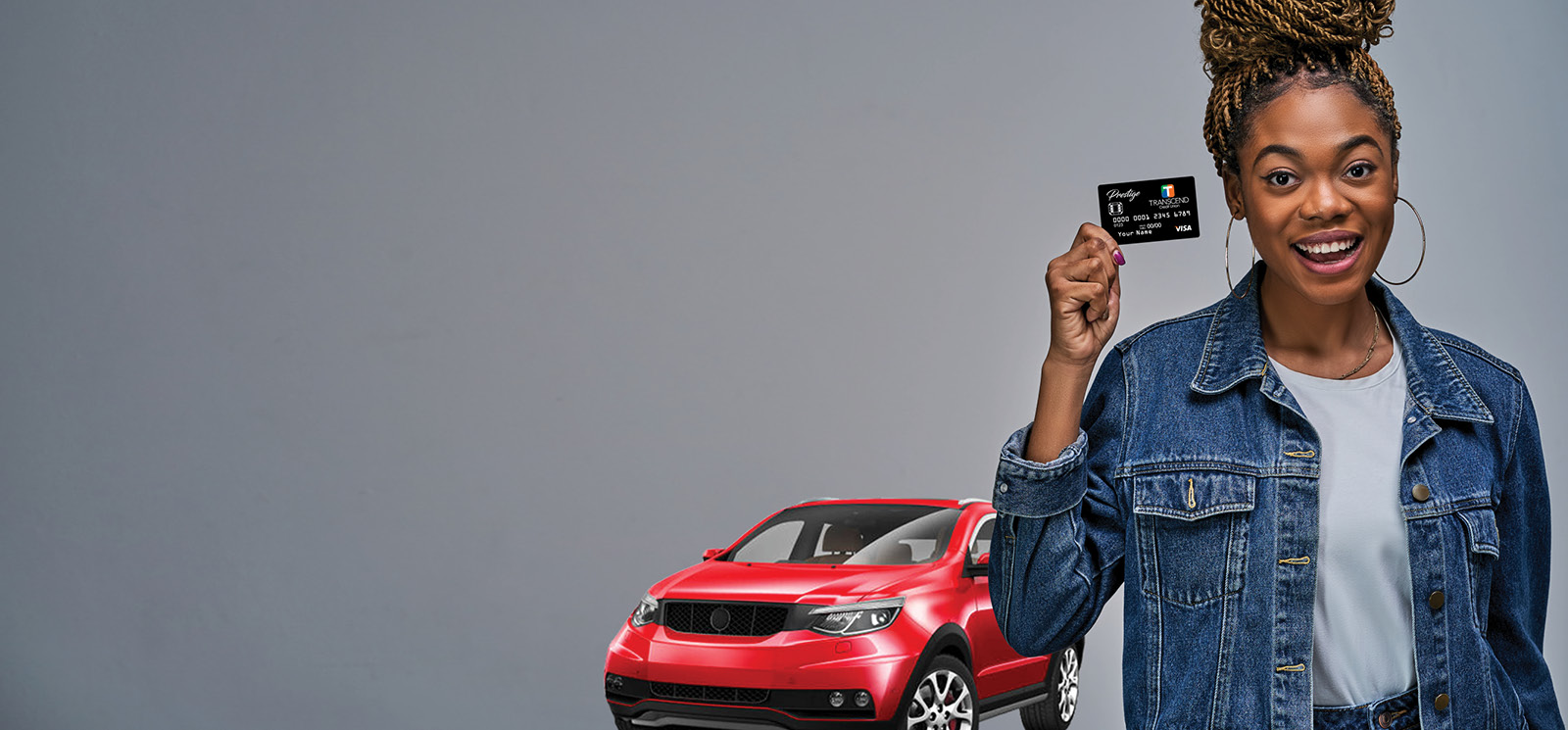 Woman with car holding her debit card