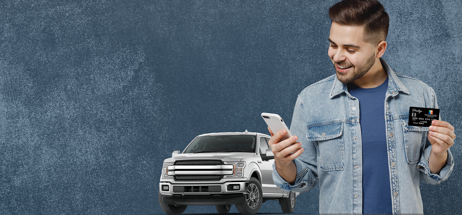 young man with credit card and truck looking at his phone