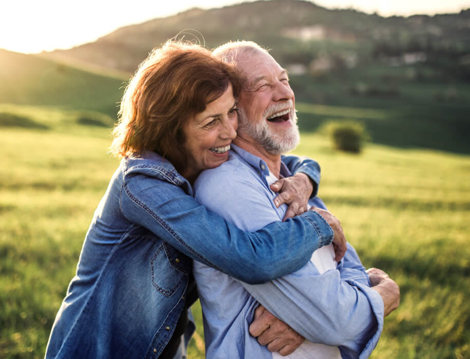 Mature couple embracing in a field
